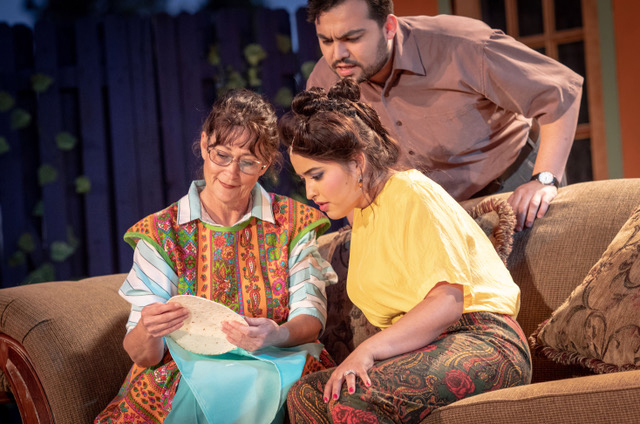 Cast members of Our Lady of the Tortilla, clockwise from left to right, Joanna Barnett, Eddie Molinar, and Alondra Flores examine the miracle tortilla.