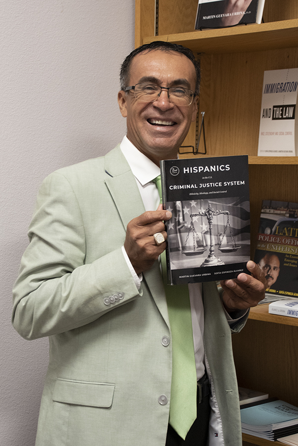 Dr. Martin Urbina holds his top ranked book. - SRSU photo